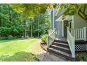 Landscaped side yard featuring green lawn, mature trees, and stone pathway at 2849 Rue Sans Famille, Raleigh, NC 27607