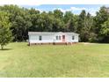 Well-maintained house set on a spacious grassy lot with mature trees at 2932 Bramblegate Dr, Mebane, NC 27302