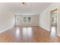 Inviting living area with gleaming wood floors and ample natural light at 2932 Bramblegate Dr, Mebane, NC 27302