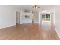 Bright living room featuring wood floors, sliding glass doors, and a built-in bar at 2932 Bramblegate Dr, Mebane, NC 27302