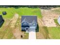 An aerial view of this charming home on a verdant lot showing its driveway and roof at 316 Robert Howe Dr, Fuquay Varina, NC 27526
