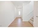 Bright foyer features wood-look floors, stairway and a front door with decorative glass at 316 Robert Howe Dr, Fuquay Varina, NC 27526