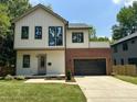 Charming two-story home with brick and modern design, complemented by a well-maintained lawn at 333 Merrywood Dr, Raleigh, NC 27610