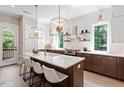 Spacious kitchen with white counters, dark cabinets, a large island and pendant lighting at 333 Merrywood Dr, Raleigh, NC 27610