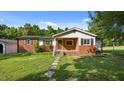 Charming brick home with a well-manicured lawn and inviting front porch at 3701 Oak Grove Church Rd, Mebane, NC 27302