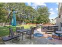Backyard featuring a patio, dining area, hot tub, and lush lawn at 3814 Tyler Bluff Ln, Raleigh, NC 27616