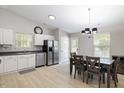 Bright eat-in kitchen with stainless steel appliances and white cabinetry at 3814 Tyler Bluff Ln, Raleigh, NC 27616