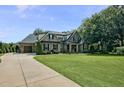 Stately home with a large driveway and a well-maintained lawn, showcasing classic design at 39 Wood Stork Ct, Clayton, NC 27520