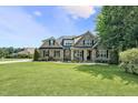 Charming brick home with manicured lawn, professional landscaping, and inviting front porch at 39 Wood Stork Ct, Clayton, NC 27520