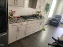 Modern kitchen with granite countertops, subway tile backsplash, and stainless steel appliances at 4108 Cross Timber Ln, Raleigh, NC 27603