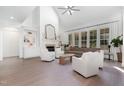 Bright living room with hardwood floors, a fireplace, built-in bookshelves, and large windows at 4228 Fawn Lily Dr, Wake Forest, NC 27587