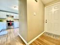 Entryway view of a kitchen featuring stainless steel appliances and white cabinets at 4324 Halliwell Dr, Raleigh, NC 27606