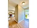 Inviting entryway featuring wood-look flooring with a view of the kitchen with stainless steel appliances at 4324 Halliwell Dr, Raleigh, NC 27606