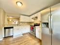 Well-lit kitchen with white cabinets, stainless steel appliances, and a window over the sink at 4324 Halliwell Dr, Raleigh, NC 27606