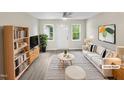 Bright living room with neutral decor, modern furniture and fixtures, and ample natural light at 448 Chinaberry Ln, Angier, NC 27501