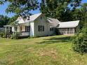 Quaint two-story home with a metal roof and a screened-in porch at 462 Ashland Dr, Goldston, NC 27252