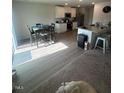Bright living room featuring hardwood floors, modern furnishings, and an adjacent kitchen with granite countertops at 484 Crow Field St, Roxboro, NC 27574