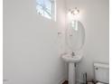 Half bathroom with modern fixtures and a pedestal sink at 485 Hawksbill Dr, Franklinton, NC 27525