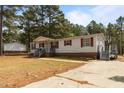 Inviting single-story home with red shutters, covered front porch, and a long driveway at 51 Brafford Estates Dr, Cameron, NC 28326
