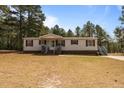 Charming single-story home featuring red shutters, a covered front porch, and a well-maintained lawn at 51 Brafford Estates Dr, Cameron, NC 28326