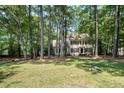 Traditional two-story home surrounded by lush greenery offering privacy and curb appeal at 5113 Linksland Dr, Holly Springs, NC 27540