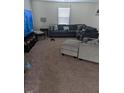 Comfortable living room with plush carpeting, a large sectional sofa, and a TV entertainment center at 512 Crow Field St, Roxboro, NC 27574