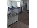 Open-concept living space with kitchen island, dining area, and modern appliances at 512 Crow Field St, Roxboro, NC 27574