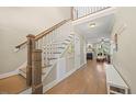 Elegant foyer featuring a staircase with wood railings and hardwood floors at 512 Mill Hopper Ln, Apex, NC 27502