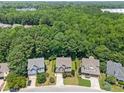 Aerial view of suburban homes surrounded by lush trees providing privacy and a sense of community at 529 Lake Gaston Dr, Fuquay Varina, NC 27526