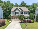 Charming two-story home with a stone-accented facade, inviting curb appeal, and attached two car garage at 529 Lake Gaston Dr, Fuquay Varina, NC 27526