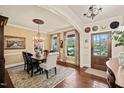 Stylish dining room featuring hardwood floors, decorative lighting, and large windows at 53 Lake Wendell Rd, Wendell, NC 27591