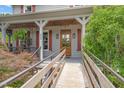 Inviting front porch features wooden accents, string lights, and a warm welcome sign at 53 Lake Wendell Rd, Wendell, NC 27591