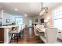 Open-concept living and dining area filled with natural light, featuring hardwood floors and modern finishes at 6147 Beale Loop, Raleigh, NC 27616