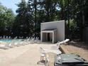 Community pool featuring ample seating and a nearby bathhouse at 7159 Sandy Creek Dr, Raleigh, NC 27615