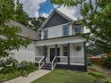 Inviting front porch with elegant columns, complemented by fresh green grass, offering a perfect spot for relaxation at 723 Lindley Dr, Durham, NC 27703