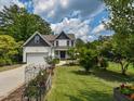 Beautiful two-story home with a manicured lawn, complemented by flower beds and a charming picket fence at 723 Lindley Dr, Durham, NC 27703