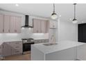 Well-lit kitchen with an island, stainless steel appliances, and designer pendant lighting at 732 Hopkins St, Durham, NC 27701