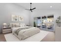Bright main bedroom boasts a ceiling fan and a sliding door to the outdoor patio at 732 Hopkins St, Durham, NC 27701