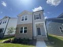 Charming two-story home with a combination of brick and siding on a beautiful lawn with a clear blue sky at 805 Portland Rose Dr, Knightdale, NC 27545