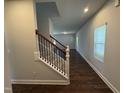 Hallway and carpeted stairs with white banisters and black metal spindles at 805 Portland Rose Dr, Knightdale, NC 27545