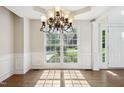 Open dining area with stylish chandelier and views of the front yard at 809 Green Passage Ln, Apex, NC 27502