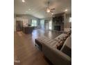 Open-concept living space boasting a stone fireplace, hardwood floors, and seamless flow to the kitchen at 820 Christian Light Rd, Fuquay Varina, NC 27526