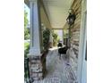 Relaxing front porch with stone columns and a brick floor at 8228 Clarks Branch Dr, Raleigh, NC 27613