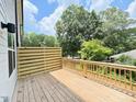 View of private outdoor deck with wood flooring and modern wood paneling and railing at 1007 Regalia Rd # 31, Durham, NC 27713