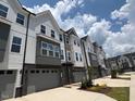Row of newly built townhomes featuring two-car garages and modern gray and white exteriors at 1007 Regalia Rd # 31, Durham, NC 27713