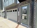 Close up of townhouse front door featuring an attached garage and brick accents at 1007 Regalia Rd # 31, Durham, NC 27713