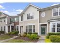 A sunny multi-story townhome with landscaped front yard and an inviting, bright exterior at 109 Grey Elm Trl, Durham, NC 27713