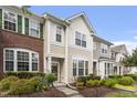 Beautiful multi-story townhome featuring diverse exterior finishes and a well-kept lawn at 109 Grey Elm Trl, Durham, NC 27713