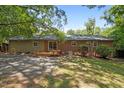 A private backyard is partially shaded with a wood deck accessible through sliding glass doors at 111 Lattimore Ln, Durham, NC 27713