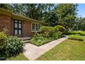 Well-kept yard and landscaping highlight the home's front entrance, featuring a brick facade at 111 Lattimore Ln, Durham, NC 27713